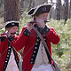musicians march dressed in 1776 Patriot outfits