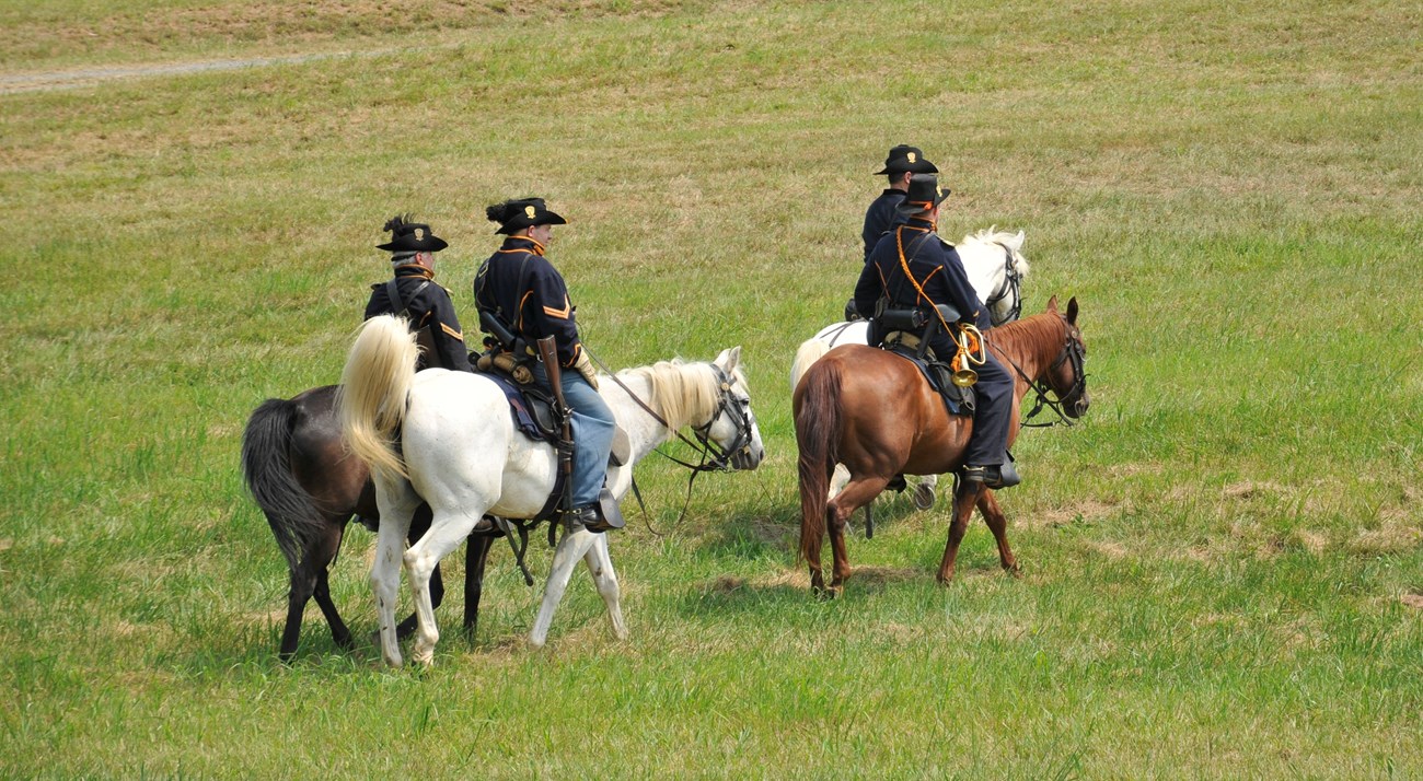 Living history performers on horseback.