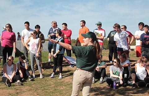 A summer intern presents a program to a group of visitors.