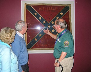 A park volunteer describes an artifact in the museum.