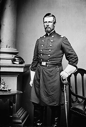Colonel Fowler, wearing a U.S. Civil War officer's uniform and with a sword in scabbard at his side, stands for a photograph