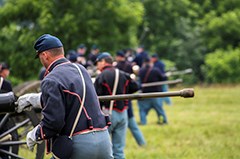 Union artillery living historians prepare to fire their cannon.