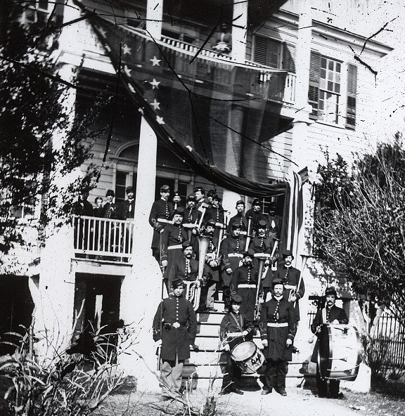 Band on Steps Musicians of a Civil War band stand on the stairs of a large house