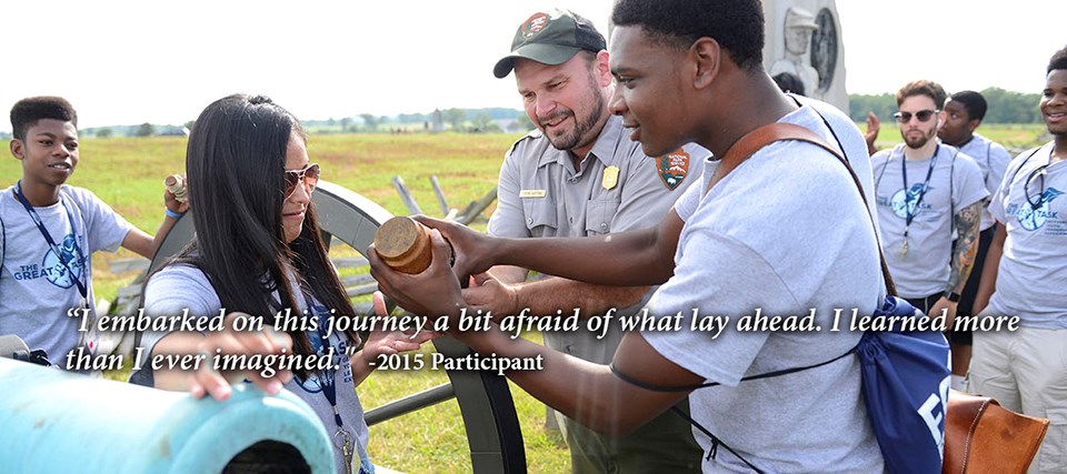 A park ranger demonstrates how to load a cannon with a Great Task class.