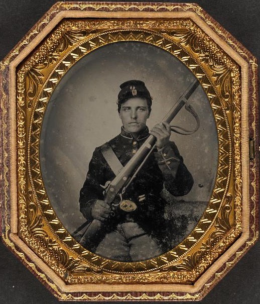 Unidentified US Civil War Soldier with Musket Photograph of a seated US Civil War Soldier holding a musket