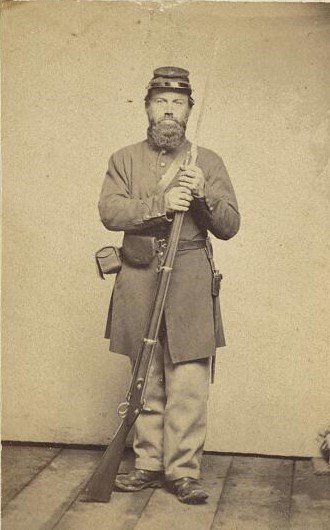 An Unidentified US Civil War Soldier Photograph of an unidentified US Civil War Soldier standing and holding a musket