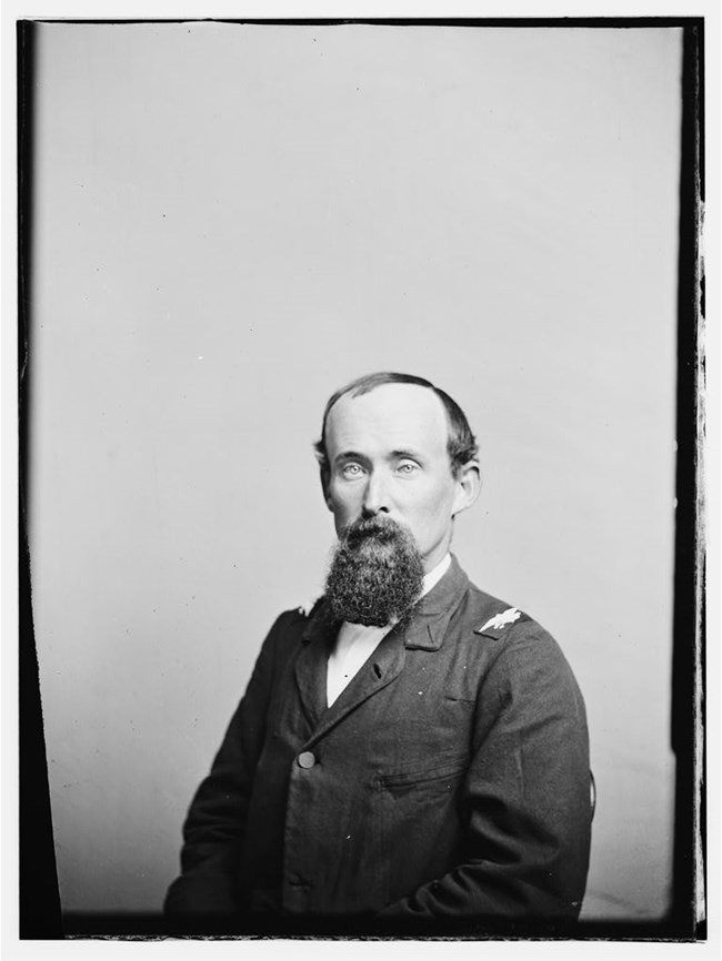 Colonel Ira Grover, wearing a U.S. Civil War officer's coat, sits for a photograph