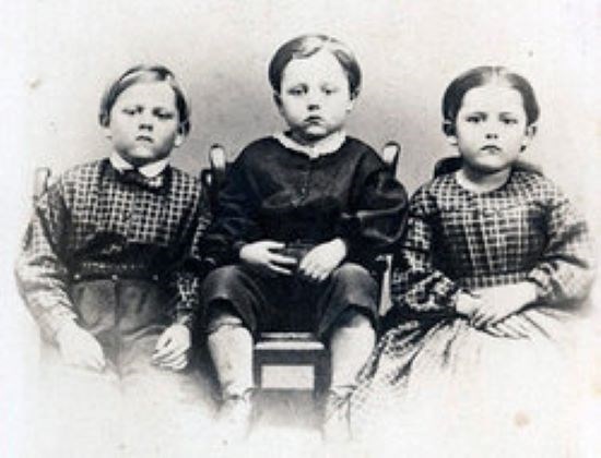 The three young Humiston children sit for a photograph