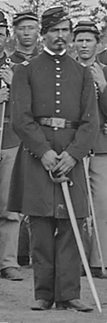Henry Stands while resting on his sword. He is wearing a Union Civil War lieutenant's uniform.