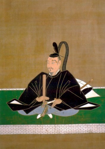 A Japanese wood block portrait of a sitting man.