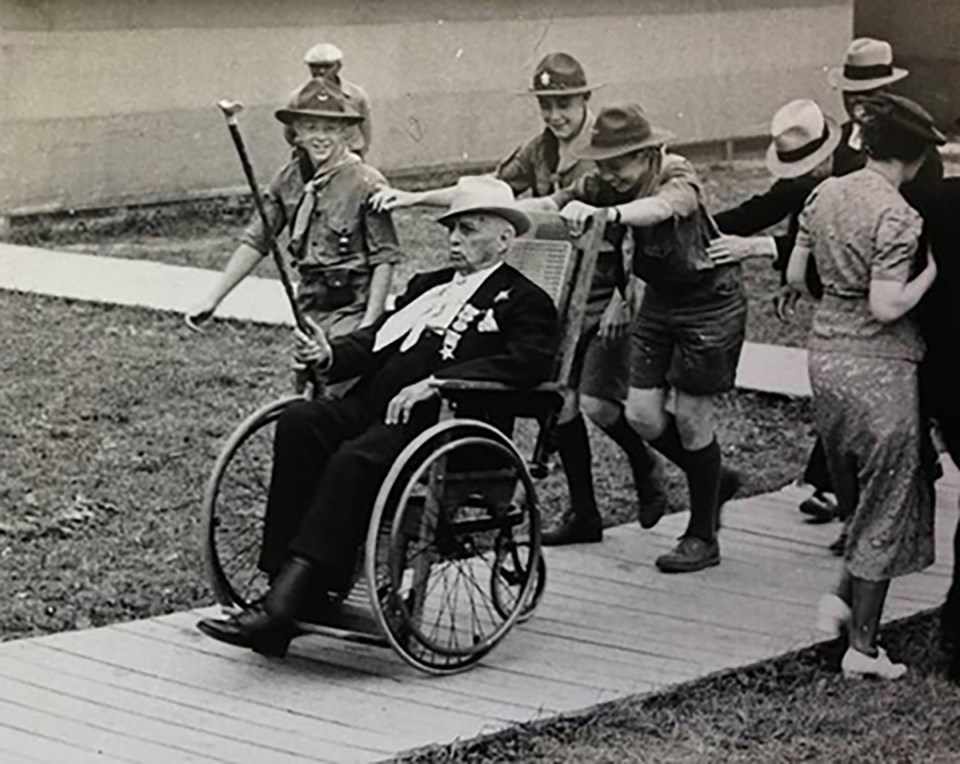 A group of boy scouts help push a veteran of the Battle of Gettysburg around in his wheel chair at the 75th Anniversary of the battle in 1938.