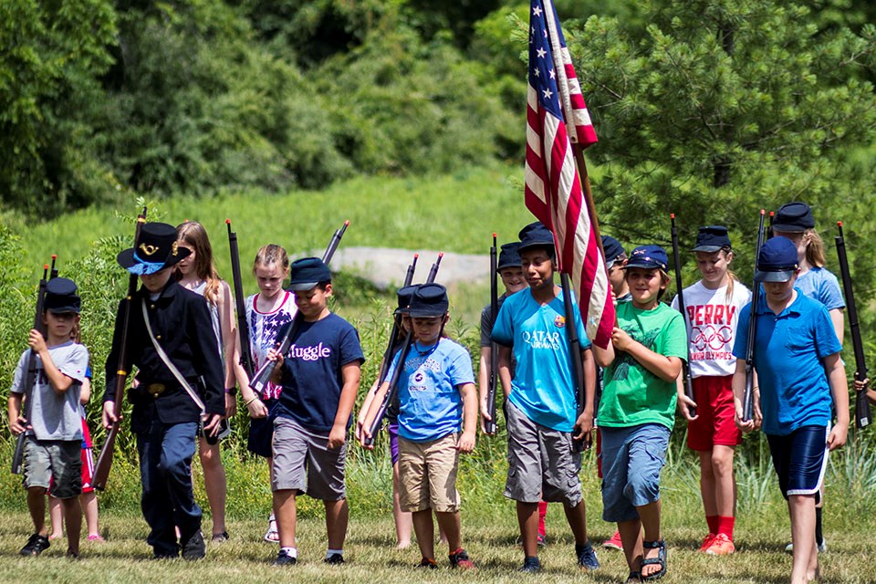 A group of children participate in marching drills during the Join the Army program.