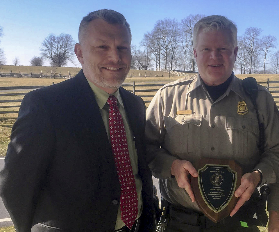 Charles Cuvelier, Chief, Law Enforcement, Security, and Emergency Services of the National Park Service (left), presented the award to Ranger John Sherman of Gettysburg National Military Park (right).