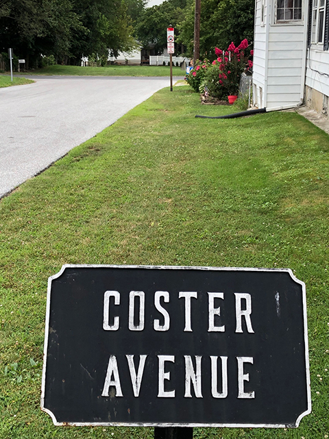 Coster Avenue. The Coster Avenue sign and the street that leads down the road.