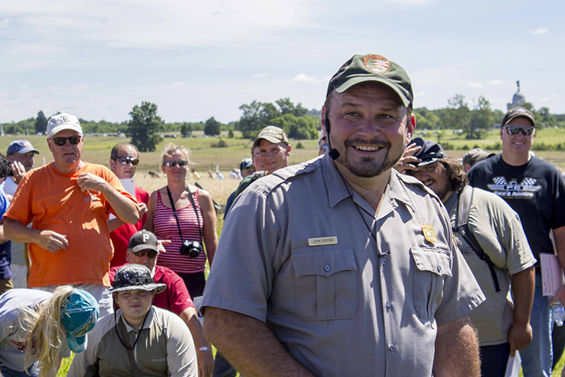 A park ranger leads a tour of the battlefield