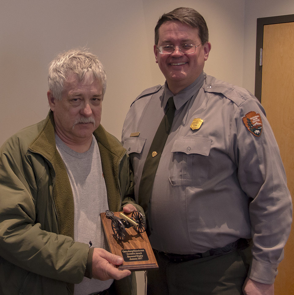 Gettysburg National Military Park superintendent, Ed Clark, presents an outstanding performance award to Ray Singley.