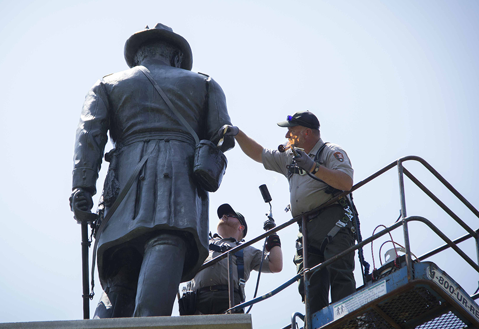 Park staff waxing the Vermont monument at Gettysburg National Military Park.