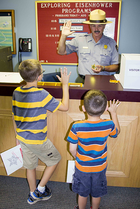 A park ranger swears in two new Junior Rangers at the Eisenhower National Historic Site.