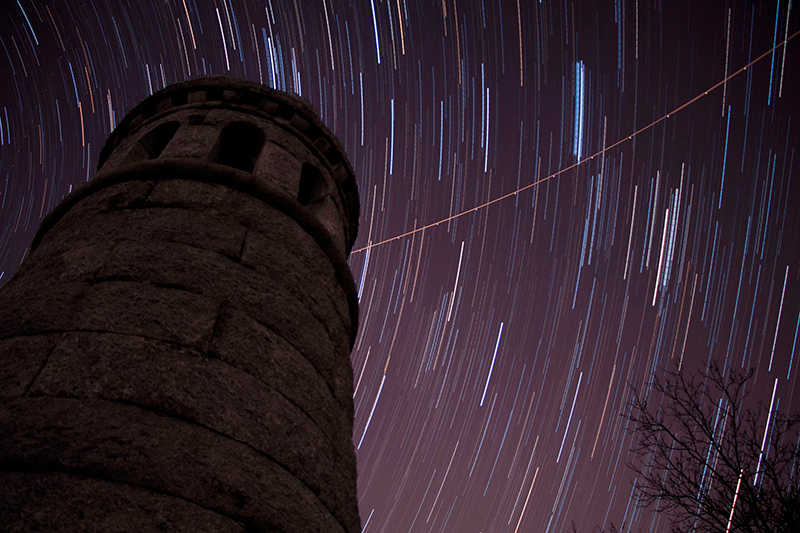 Time-lapse photo of the stars at Little Round Top with the tower of the 44th New York Infantry monument at Gettysburg National Military Park.
