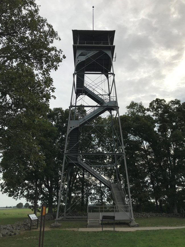 A tall steel tower with a platform on top