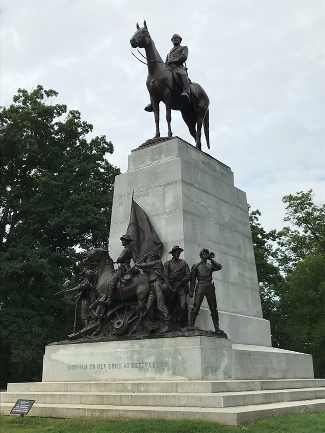 The large, 41 foot tall granite Virginia Memorial is topped by a bronze statue of General Robert E Lee on horseback; at the base of the monument are five bronze statues of Confederate soldiers