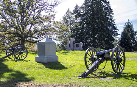 Two cannons flank the white granite obelisk monument to the 1st Massachusetts Battery. Two cannons flank the white granite obelisk monument to the 1st Massachusetts Battery.