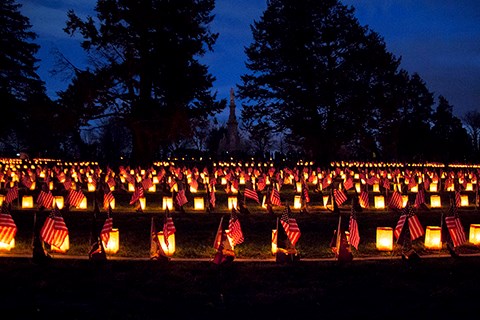 Luminaries and flags adorn the Civil War graves in the Soldiers' National Cemetery.