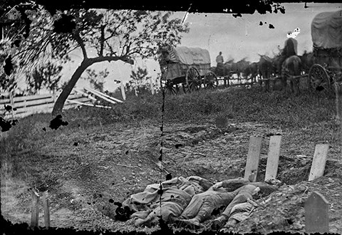 Soldiers were hastily buried in shallow graves and marked with crude wooden headboards.