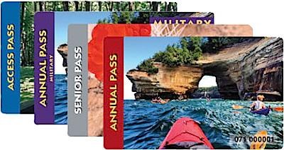 A collage of four National Park passes. They are staggered from right to left: Annual Pass, Senior Pass, Annual Pass Military, Access Pass.