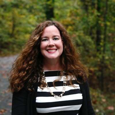 NEWS RELEASE Kerry Gonzalez Selected as Chief of Cultural Resource Management Kerry Gonzalez photographed with brown hair, black and white clothing, outdoors.