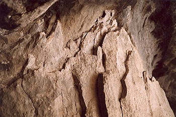 A photo of the layers of jagged edged rock that omprise the back of Cave #4 A photo of the layers of jagged edged rock that omprise the back of Cave #4