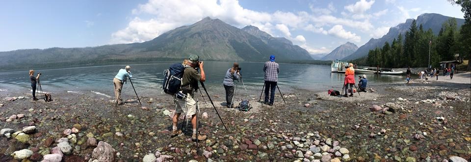 photographers set up tripods on lakeshore photographers set up tripods on lakeshore