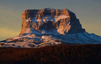 Chief Mountain with a dusting of snow at sunset.