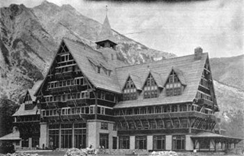 historic image of multistory hotel with many pitched gables and mountain in background