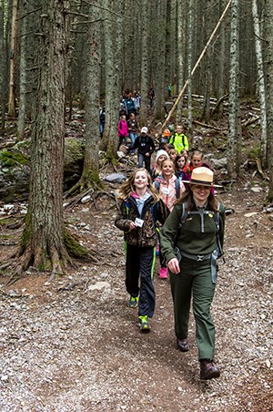 ranger leads line of kids in forest