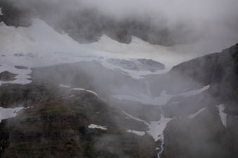 Thin clouds in front of snow and ice.