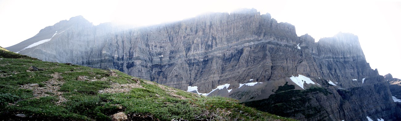 sunlight shines over mountain ridge with dark banding