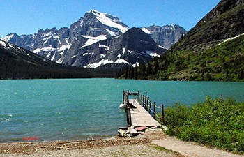 teal mountain lake with dock