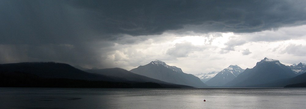 storm moving left to right over mountain lake storm moving left to right over mountain lake