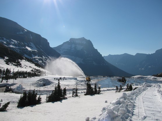 Rotary plow blowing snow out of the Logan Pass Visitor Center parking lot on July 7, 2011