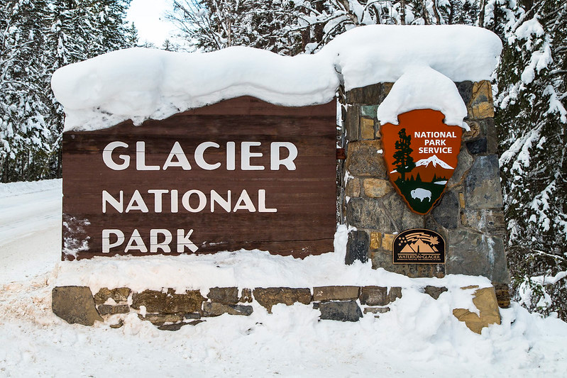 The entrance sign covered in snow