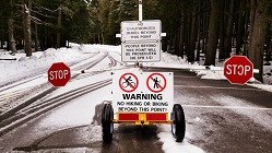 Hiker-Biker Closure Sign on Going-to-the-Sun Road with snow in background