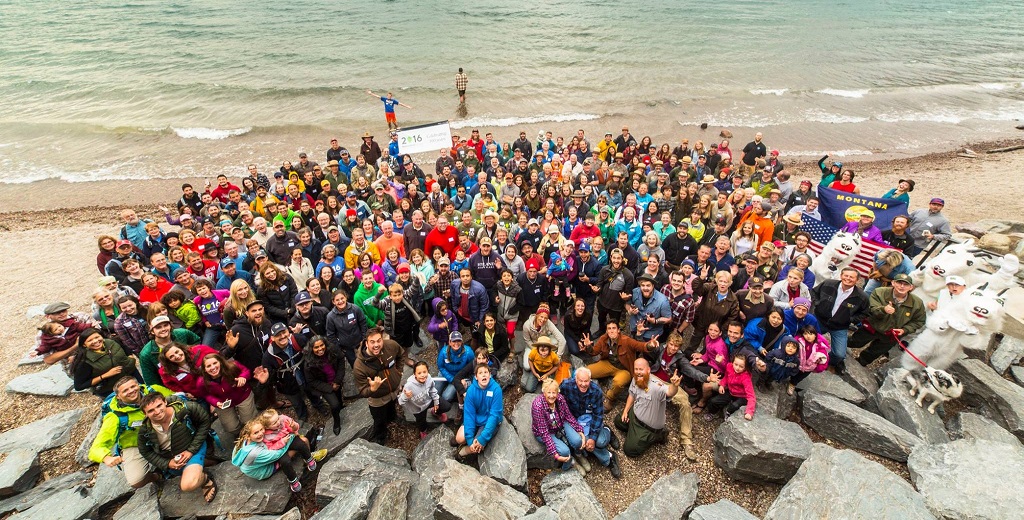 large group photo looking down at people on lakeshore large group photo looking down at people on lakeshore