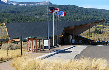 flagpoles outside of modern building with low roof