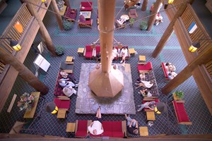overhead view of lobby with red couches surrounding fireplace