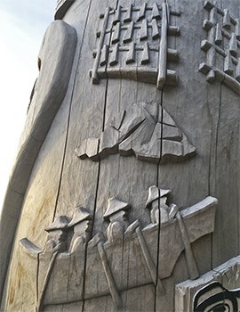 A detailed carving on the healing totem pole