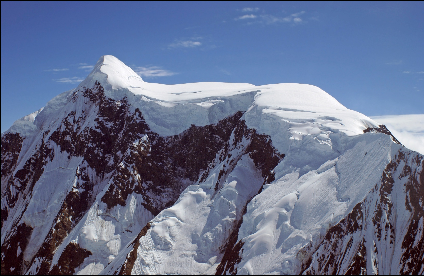 Snowy mountain peaks with blue sky in the background