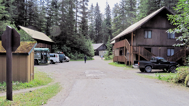 Brown wooden dorm buildings and parking lot