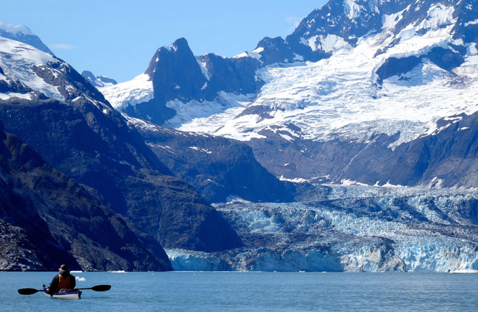 Kayker is dwarved by Johns Hopkins Inlet Kayker is dwarved by Johns Hopkins Inlet
