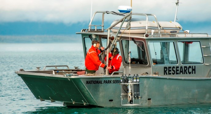 Researchers working on vessel in Glacier Bay Researchers working on vessel in Glacier Bay